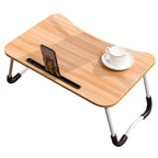 Wooden folding table with cup and phone holder on a white background