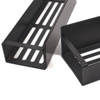Two black metal trays with slotted design on a white background