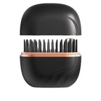 Black hairbrush with rose gold accents on a white background